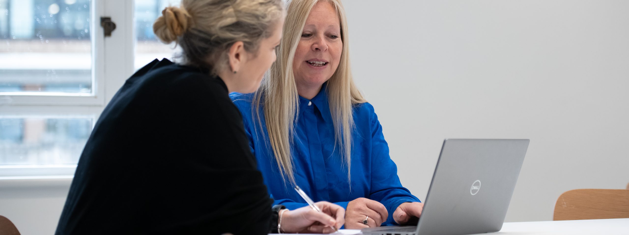 Two women looking at a computer